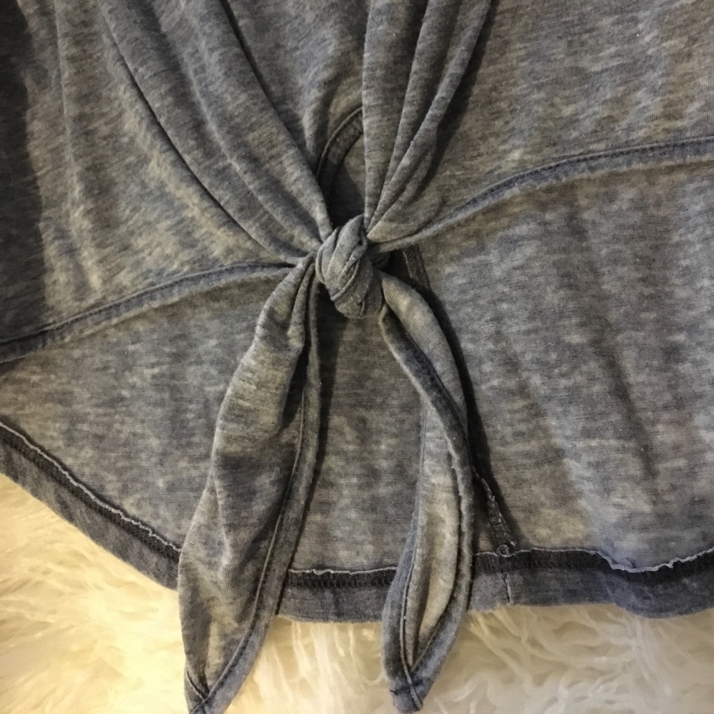 A blue tank top with tie at bottom